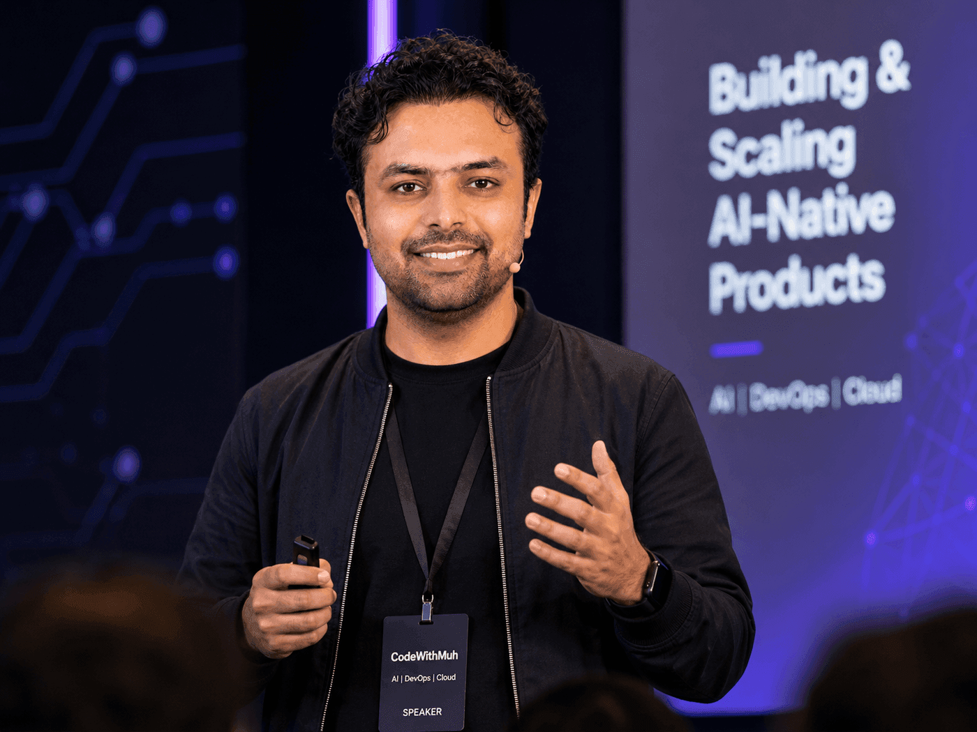 Muhammad Rashid speaking on stage about building and scaling AI-native products